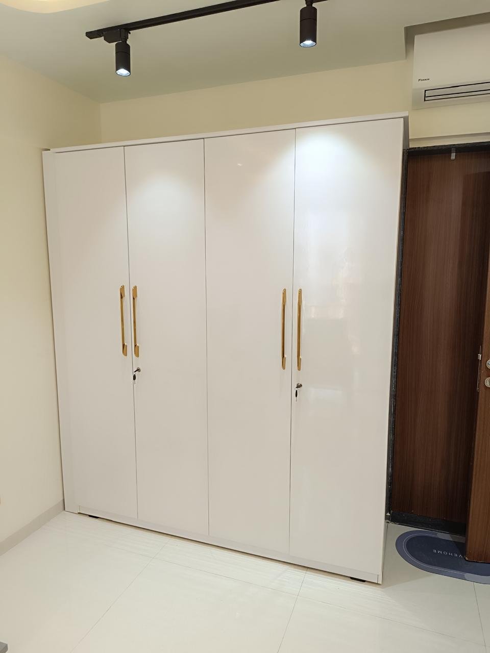 White four-door wardrobe with gold handles