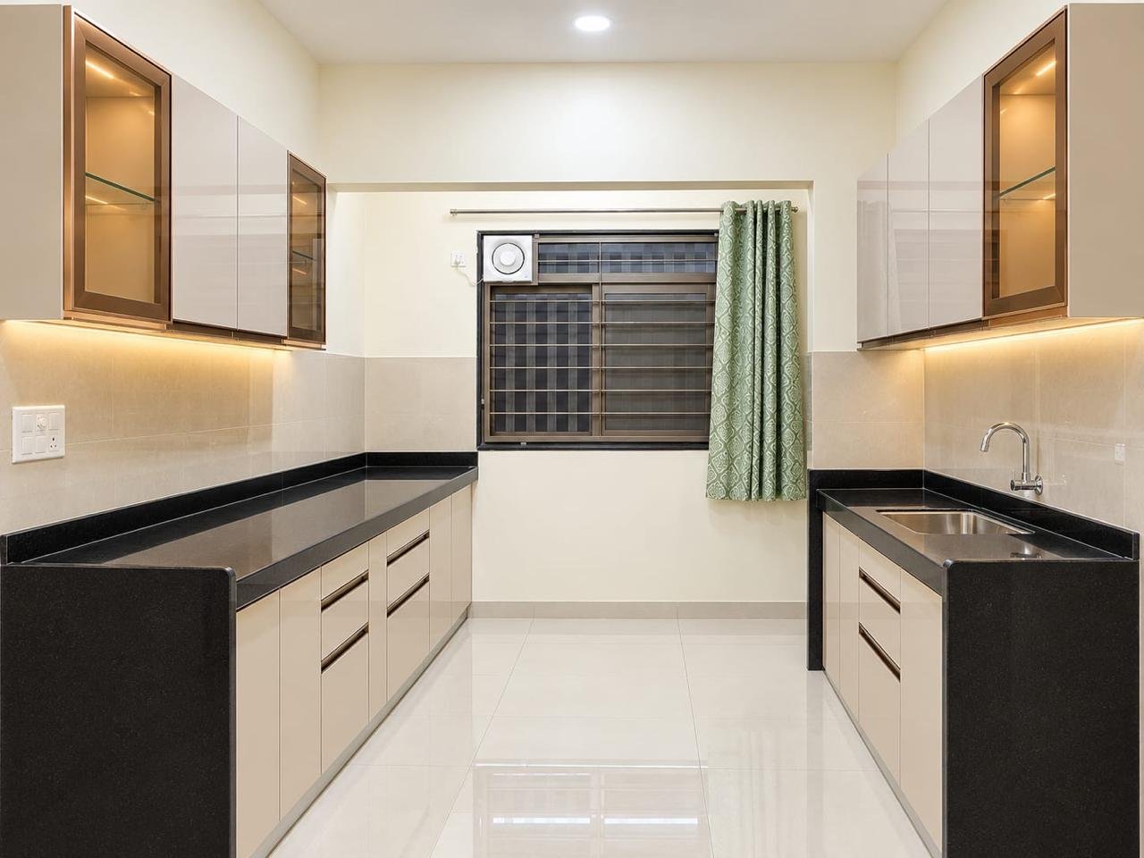Parallel modular kitchen in ivory and beige with bronze-framed glass cabinets