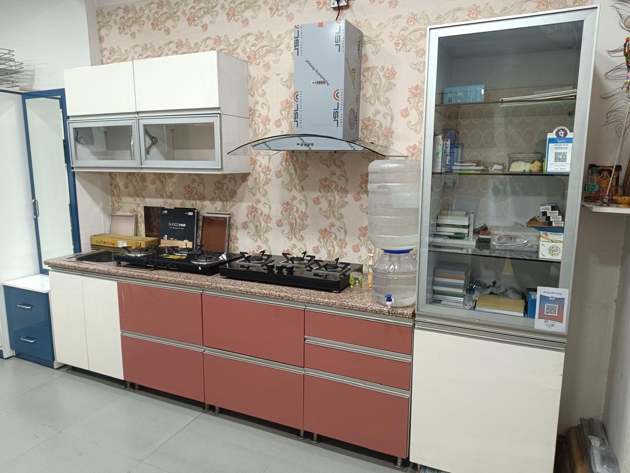 Showcase kitchen in blush pink and white with a granite countertop