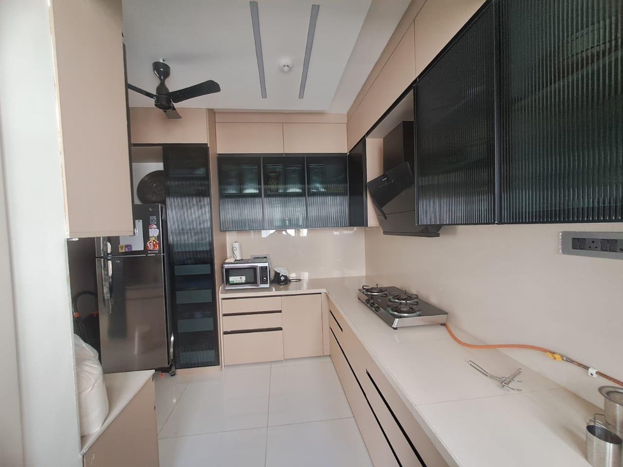 Cream storage wall with black-framed fluted glass shutters